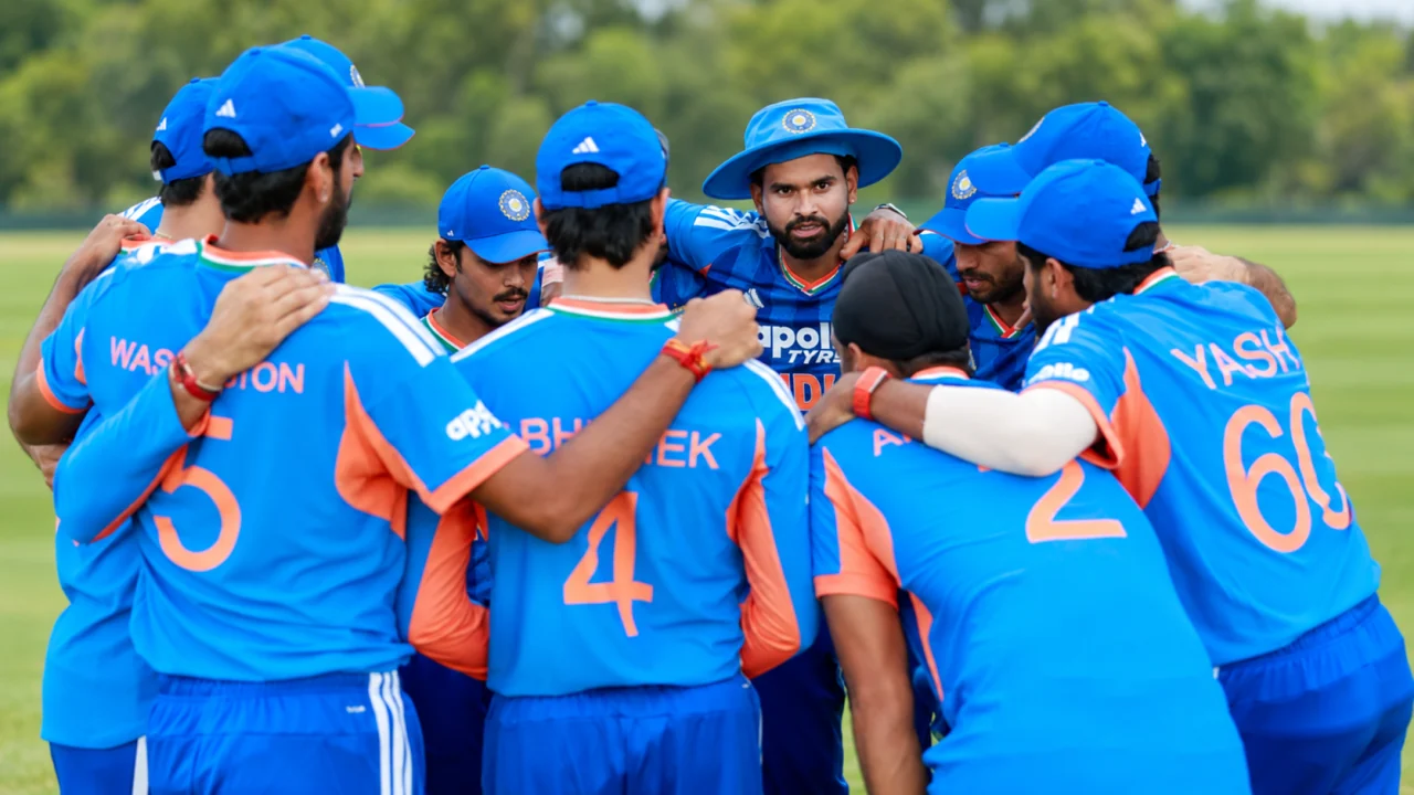 Indian men's cricket players gathered in a team huddle on a field