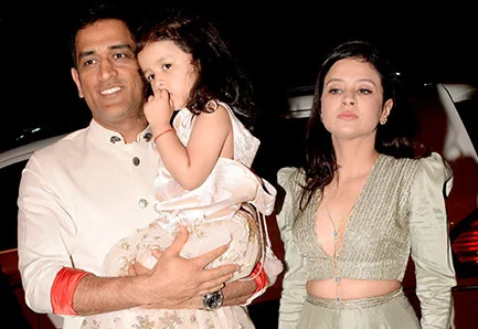 Sakshi Dhoni with MS Dhoni and their daughter at a public event